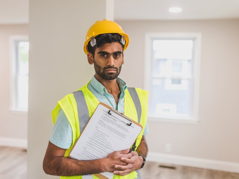 Safety inspector reviewing compliance checklist at an industrial site